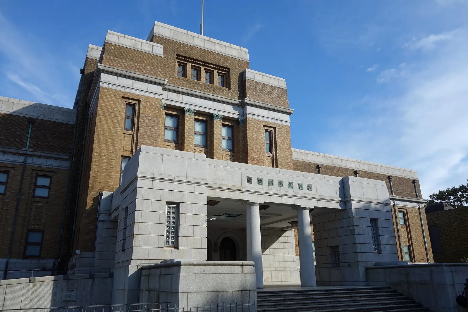 The historic brick-and-stone entrance of the National Museum of Nature and Science in Ueno Park, Tokyo.