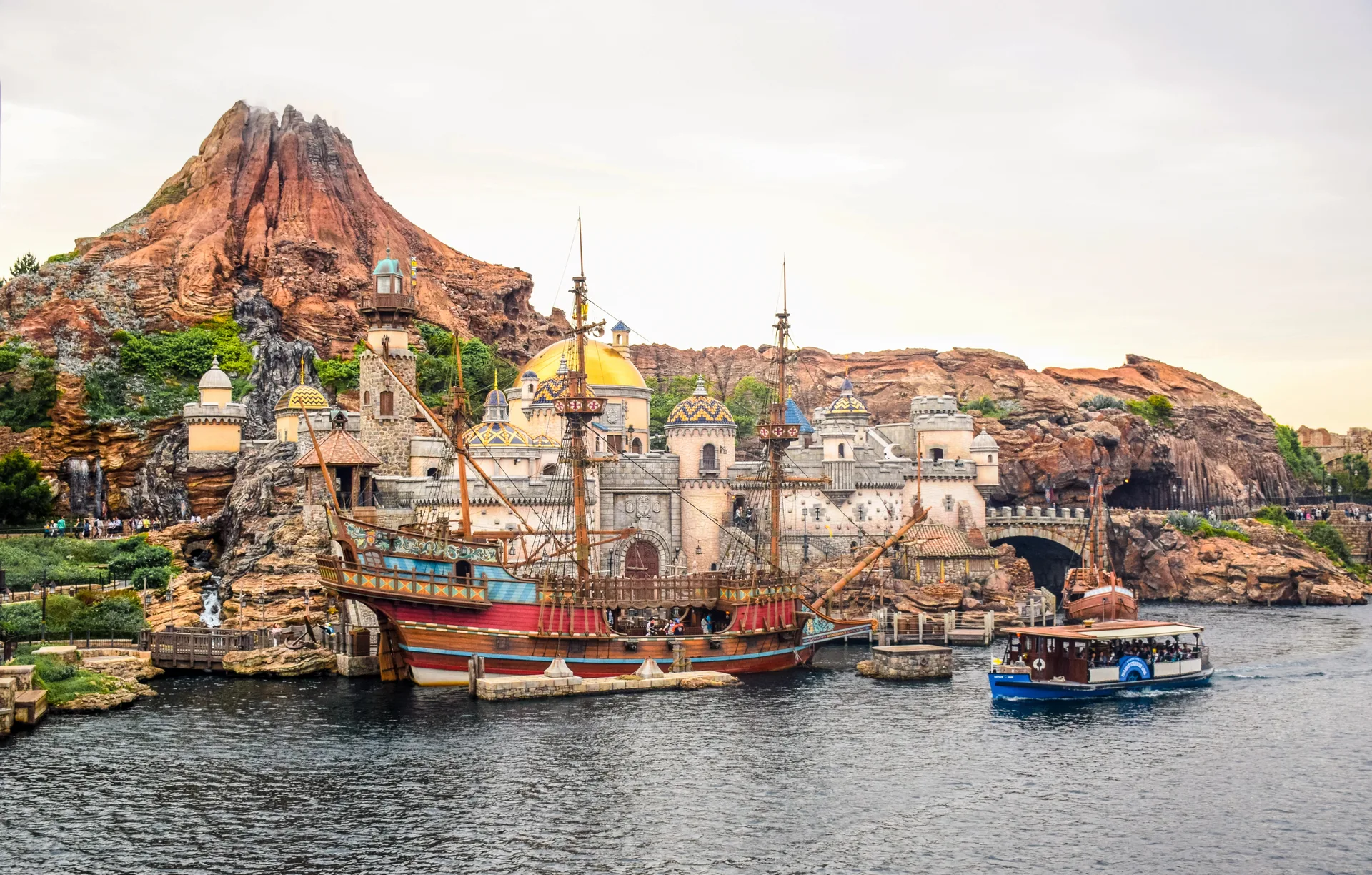 Tokyo DisneySea theme park — its harbour, tall sailing ship and the Mount Prometheus volcano.